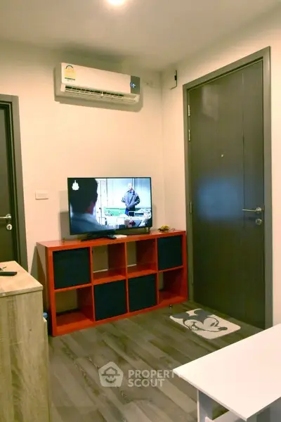 Cozy living room with modern decor and wall-mounted air conditioner