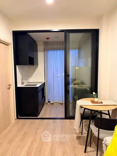 Modern compact kitchen with open layout and dining area in stylish apartment