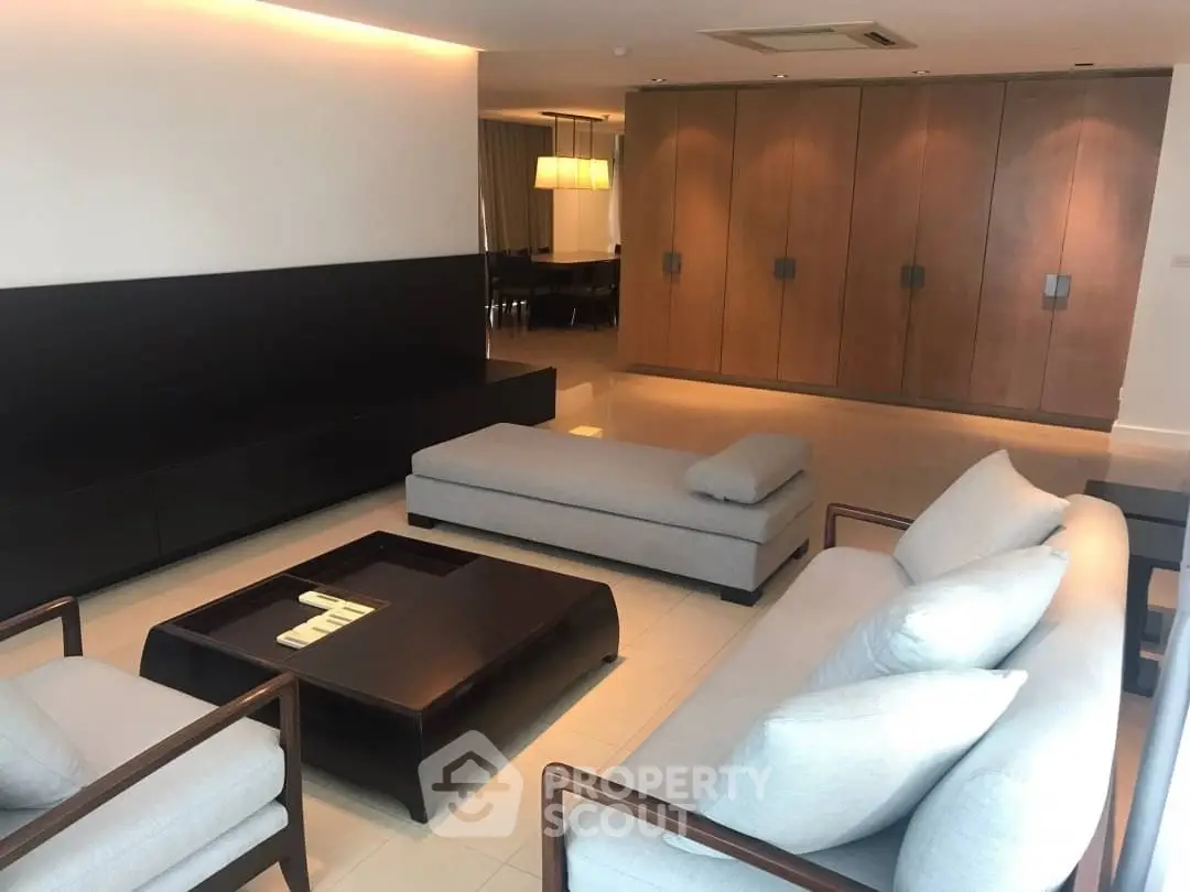 Spacious modern living room with elegant furniture and ambient lighting.