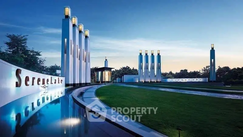Luxurious modern building entrance with elegant architectural design and serene landscaping.