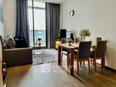 Modern living room with dining area, large window, and stylish decor.