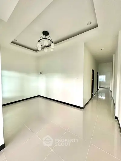 Spacious modern living room with elegant lighting and glossy tiled flooring