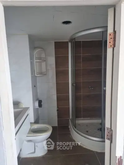 Modern bathroom with sleek shower and contemporary fixtures in a stylish real estate property.