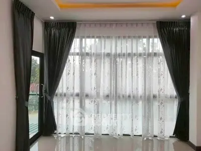 Elegant room with floor-to-ceiling windows and luxurious curtains