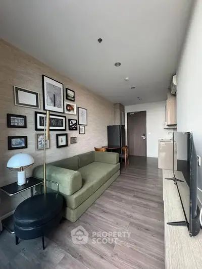 Modern living room with stylish decor and green sofa in a contemporary apartment.