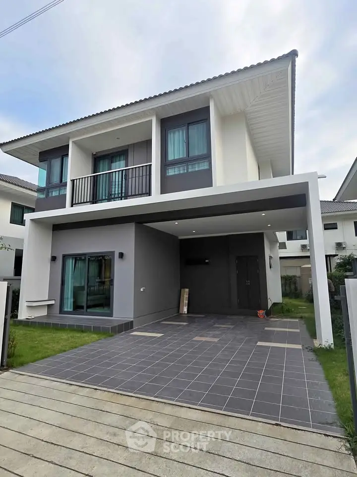 Modern two-story house with sleek design and spacious driveway