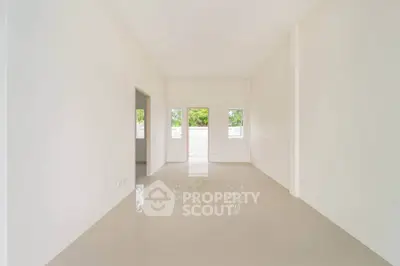 Spacious empty room with large windows and glossy tiled floor, perfect for customization.