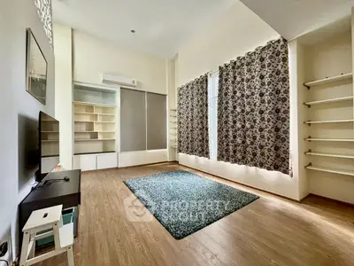 Spacious living room with modern decor and large windows