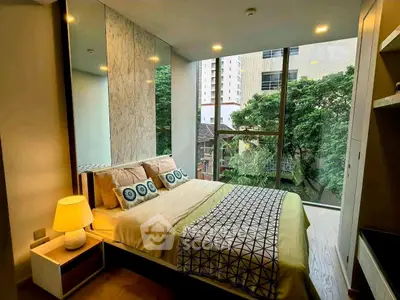 Modern bedroom with large windows and stylish decor in urban setting.