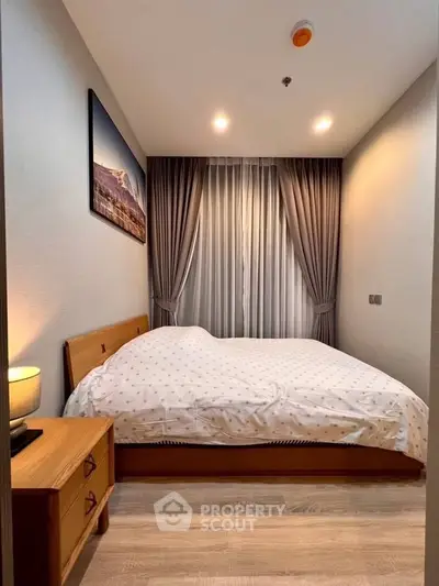 Cozy bedroom with elegant decor and soft lighting, featuring a comfortable bed and stylish curtains.