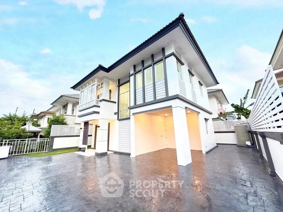 Stunning modern two-story house with spacious driveway and elegant architectural design.