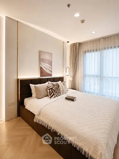 Luxurious bedroom with elegant decor and natural light, featuring a cozy bed and stylish furnishings.