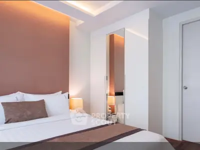 Modern bedroom with stylish decor and cozy lighting in a contemporary apartment.