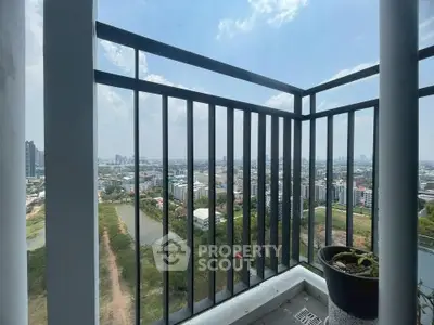 Stunning cityscape view from a high-rise balcony with sleek railing design.