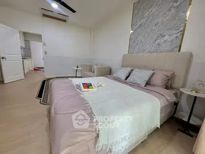 Elegant bedroom with modern decor and cozy seating area