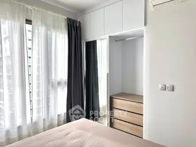 Bright bedroom with large windows and modern closet in a stylish apartment.