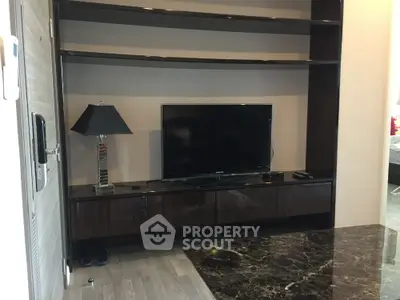 Modern living room with sleek TV unit and marble table