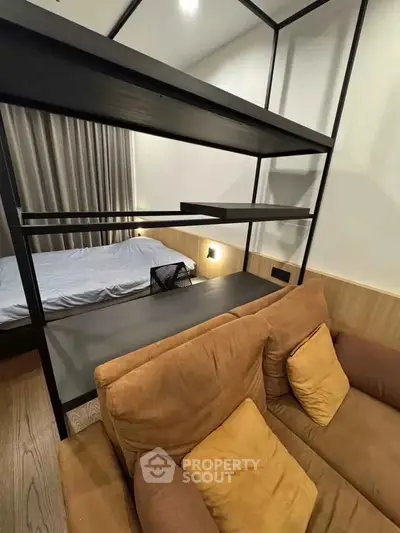 Modern studio apartment with cozy living area and stylish shelving