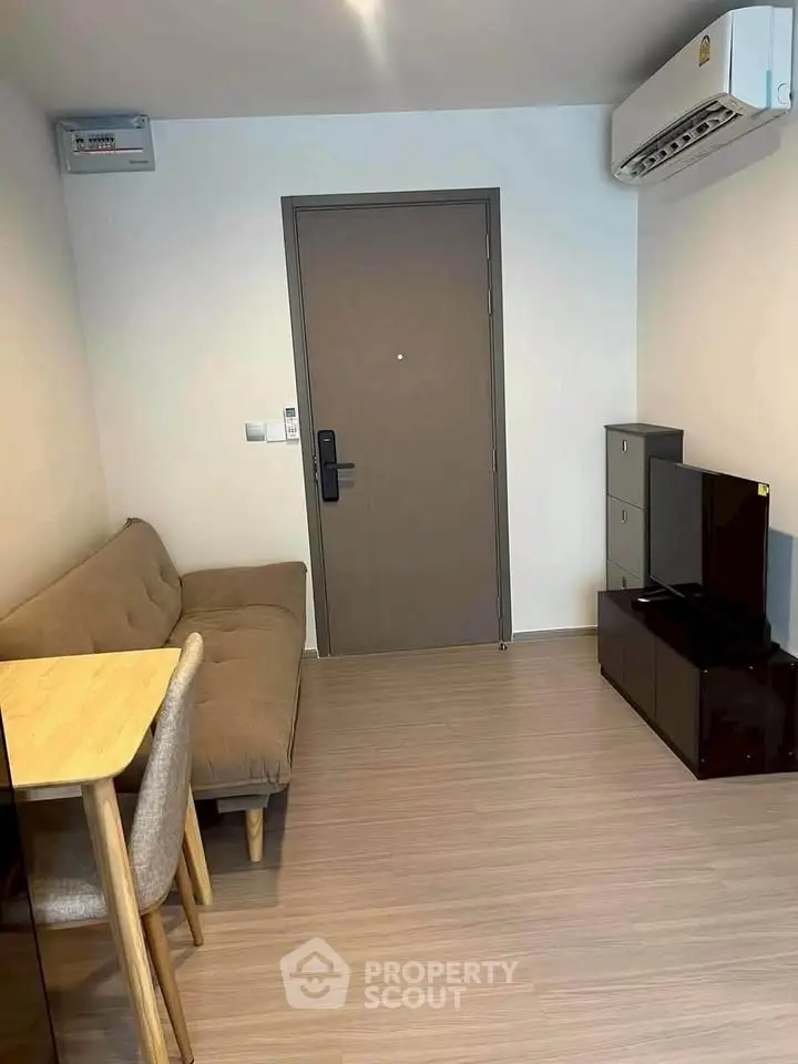 Cozy living room with modern furniture and air conditioning in a compact apartment.