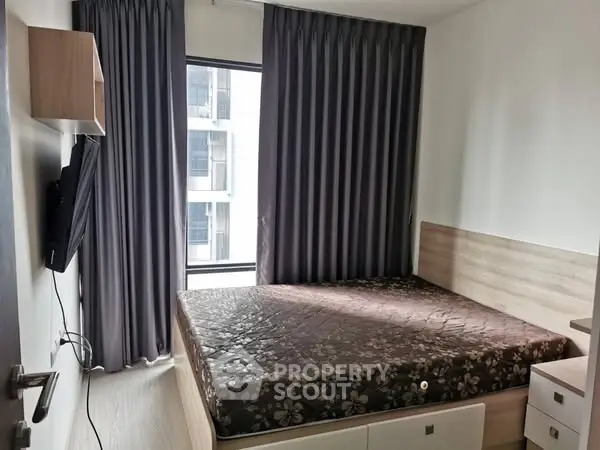 Modern bedroom with large window and stylish curtains in a contemporary apartment.