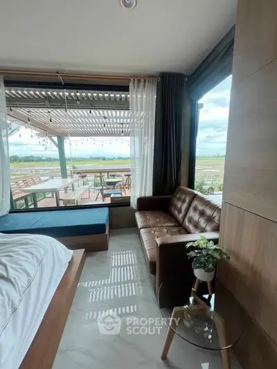 Charming bedroom with stunning view and cozy seating area, perfect for relaxation.