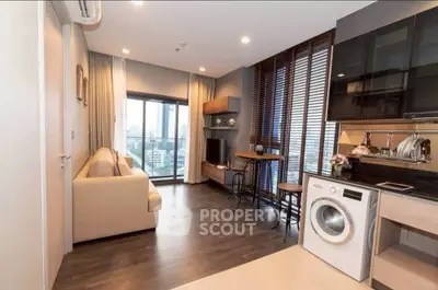 Modern living room with city view, cozy sofa, and in-unit washing machine.