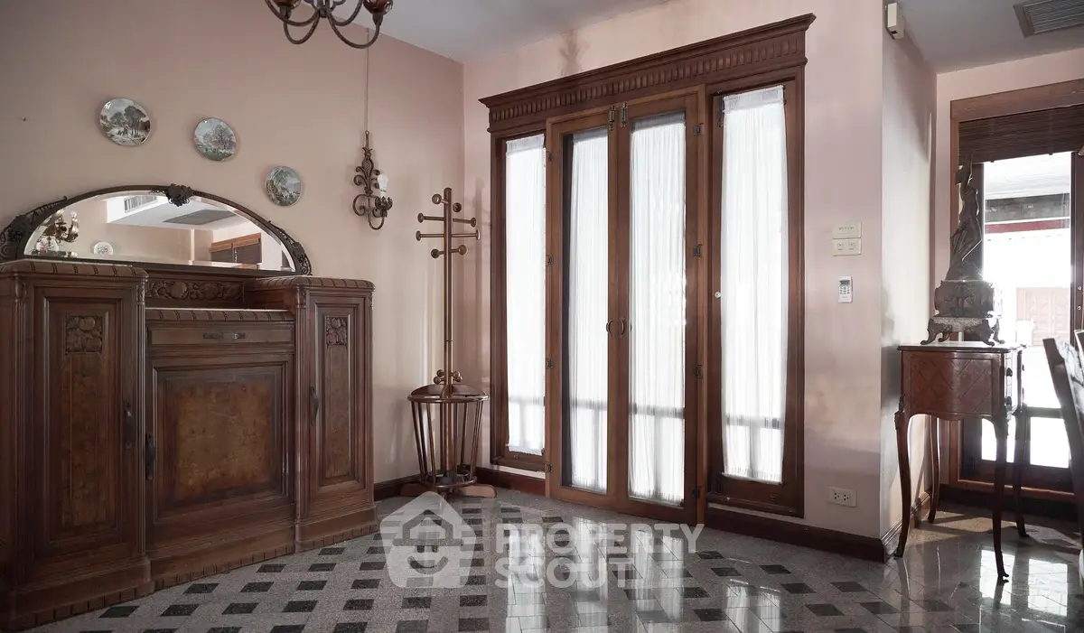 Elegant vintage-style living room with wooden furniture and decorative accents.