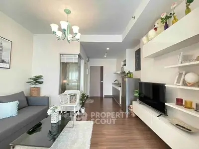 Modern living room with stylish decor and open layout, featuring sleek furniture and elegant lighting.