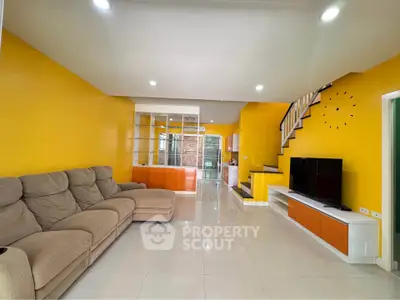 Spacious modern living room with vibrant yellow walls and cozy sectional sofa