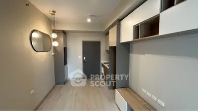 Modern minimalist apartment interior with sleek built-in storage and stylish lighting.