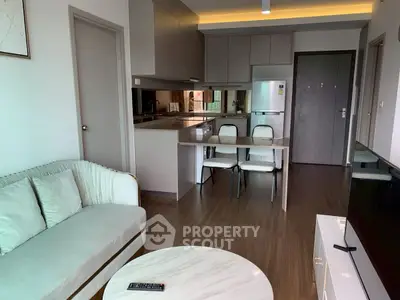 Modern open-plan living room and kitchen with sleek design and neutral tones.