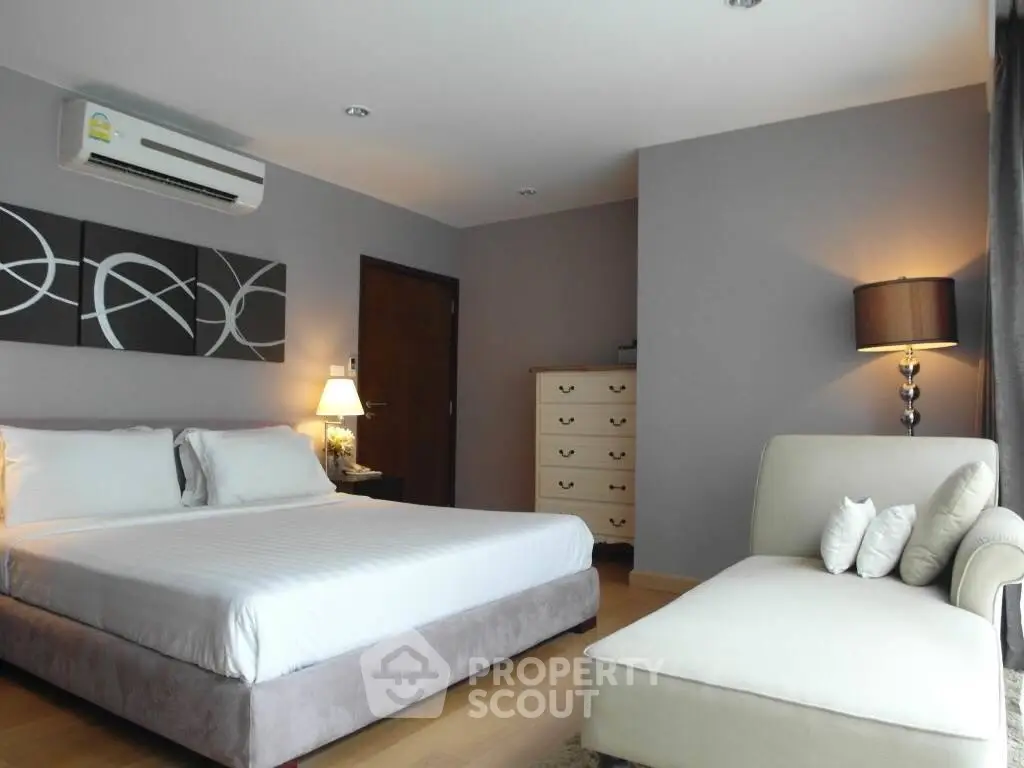 Spacious modern bedroom with elegant decor and natural light