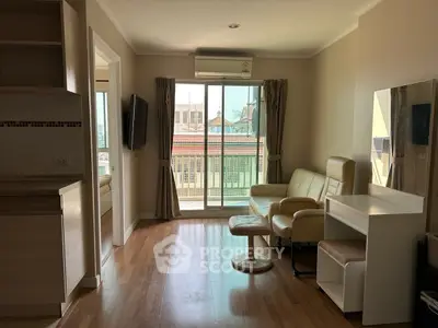 Modern living room with balcony view, featuring stylish furniture and natural light.