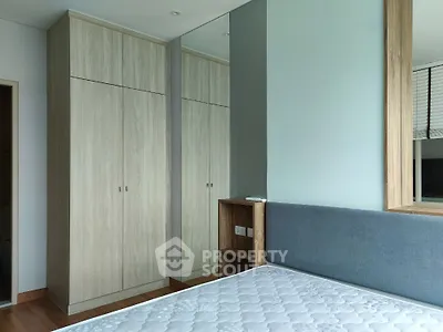 Spacious bedroom with modern wardrobe and comfortable bed in a stylish apartment