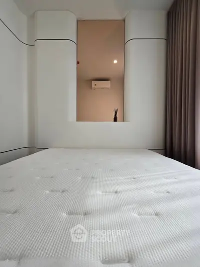 Modern minimalist bedroom with sleek design and air conditioning unit
