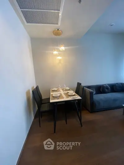 Modern dining area with elegant table setting and cozy seating in a stylish apartment.