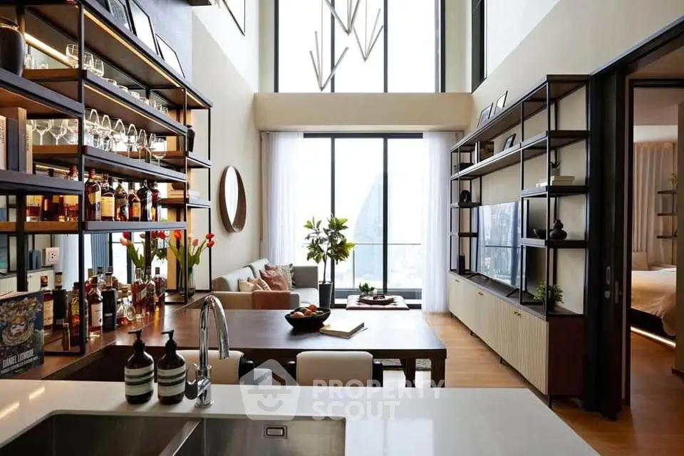 Luxurious modern living room with high ceilings, large windows, and elegant decor in a stylish apartment.