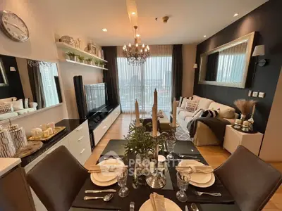 Luxurious modern living room with elegant decor and dining area, featuring a chandelier and large windows.