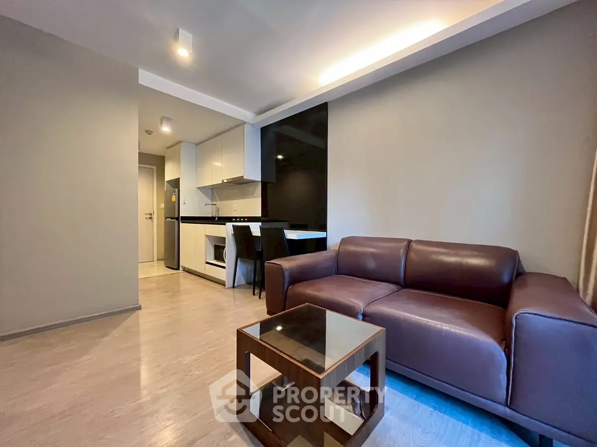 Modern living room with sleek furniture and open kitchen layout