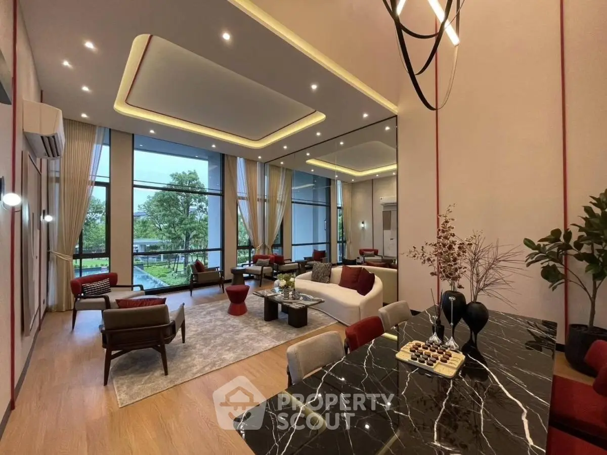 Luxurious modern living room with elegant decor and large windows offering garden views.