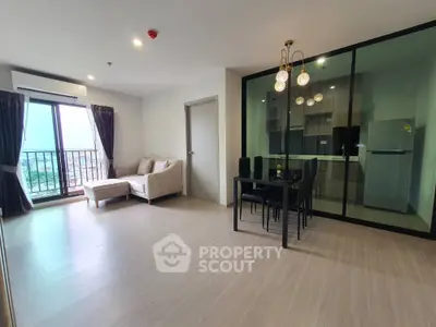 Spacious modern living room with open kitchen and balcony view