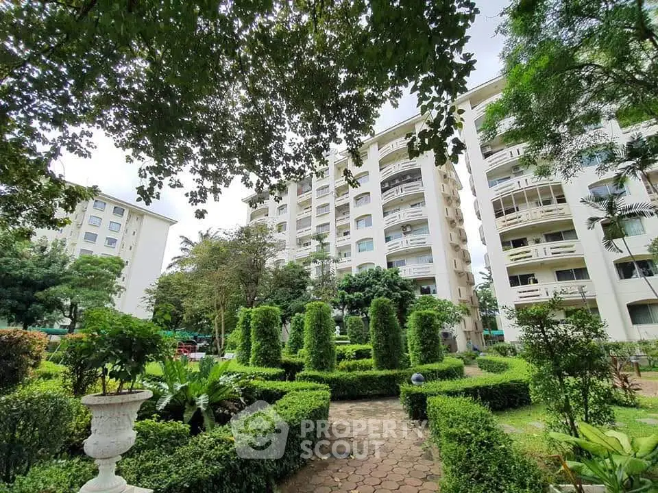 Luxurious apartment building with lush garden view in prime location