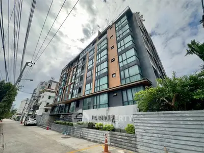 Modern urban apartment building with sleek design and lush greenery, perfect for city living.