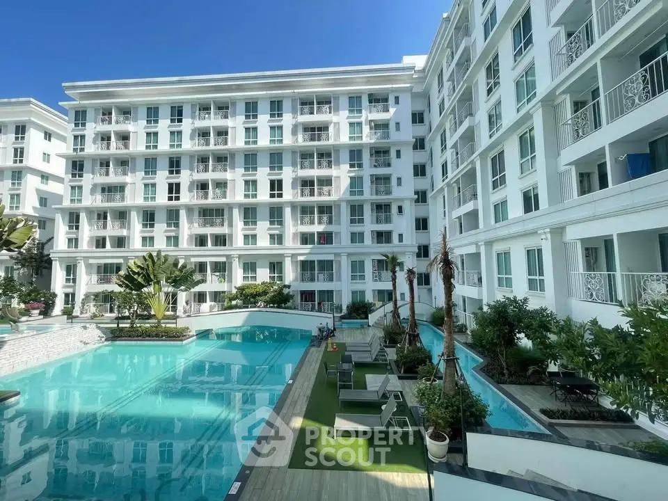 Luxurious condominium with stunning pool and lush landscaping, perfect for modern living.