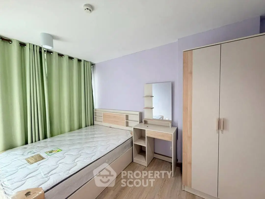Spacious bedroom with modern furniture and natural light