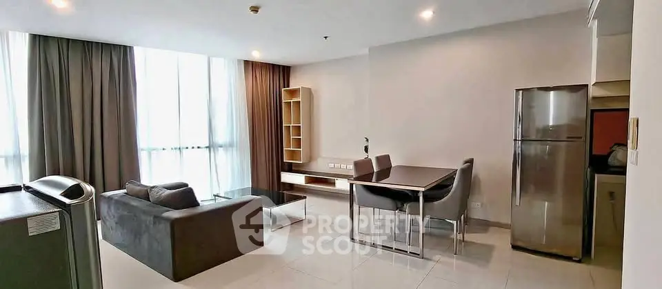 Spacious modern living room with dining area and large windows in a stylish apartment.