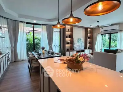 Luxurious open-plan living room with elegant dining area and garden view.