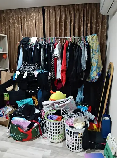 Spacious bedroom with ample storage and clothing racks, perfect for organizing your wardrobe efficiently.