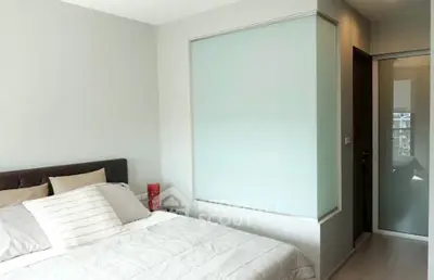 Modern bedroom with sleek design and cozy ambiance, featuring a comfortable bed and stylish decor.