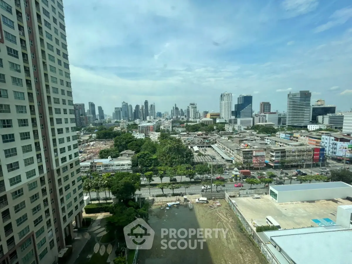 Stunning cityscape view from high-rise building, showcasing urban skyline and lush greenery.